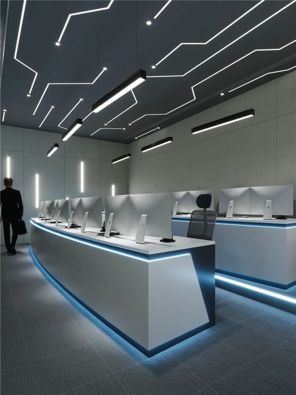 Emircom control room consoles under a linear light-track ceiling, fitted out by AGC